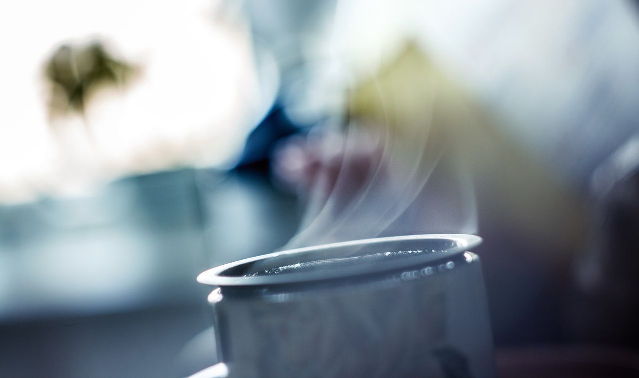 Young couple with coffee in winter outside